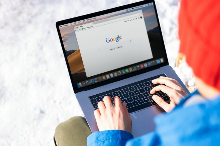 Man on laptop using Google